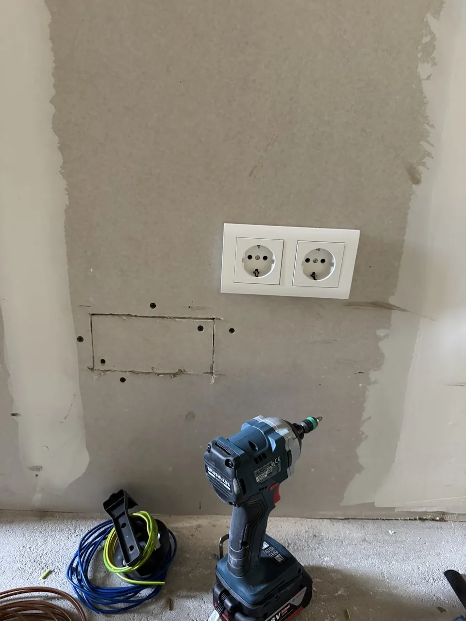 New double electrical socket installed in an opened plasterboard wall in Tilburg